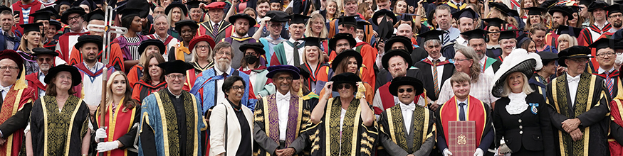 Graduates surround the library quad as they prepare for group photograph